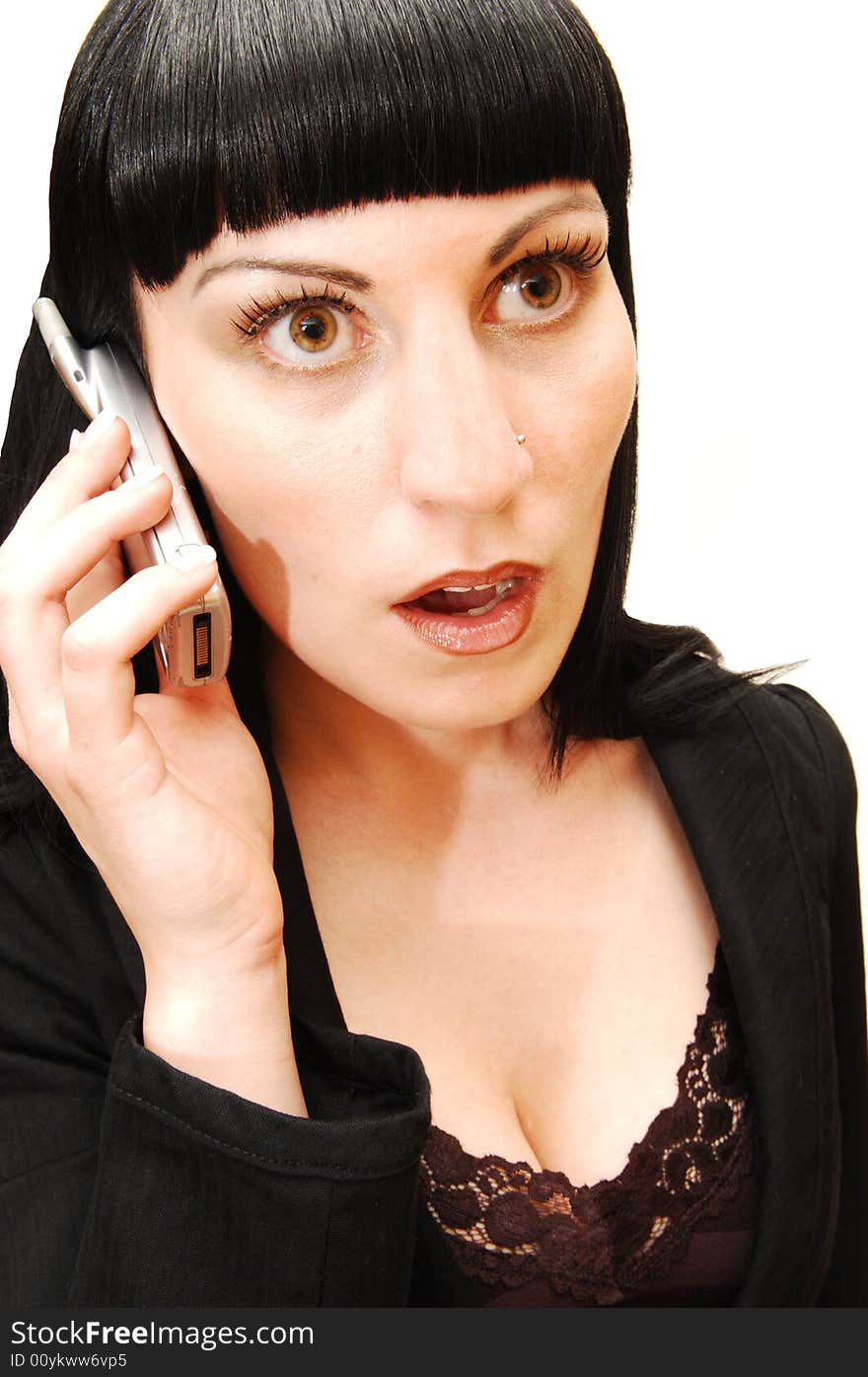 An serous looking businesswoman in a black suit and strait hair talking on 
her cell phone. An serous looking businesswoman in a black suit and strait hair talking on 
her cell phone.