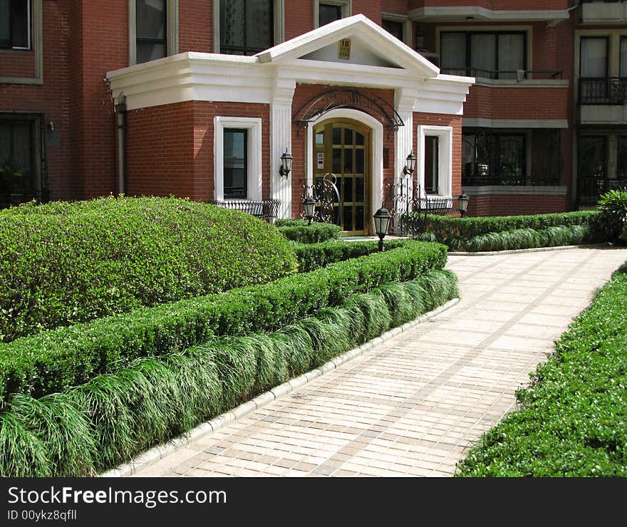 View of a beautiful house with a green garden. View of a beautiful house with a green garden