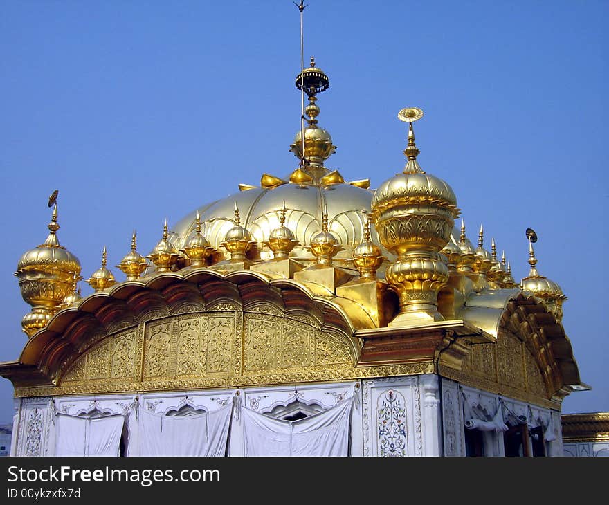 A Golden plated dome of the golden temple in India. A Golden plated dome of the golden temple in India