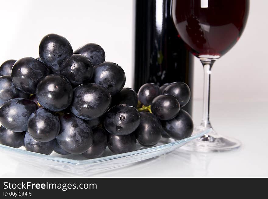 Glass of red wine and grapes. Glass of red wine and grapes.