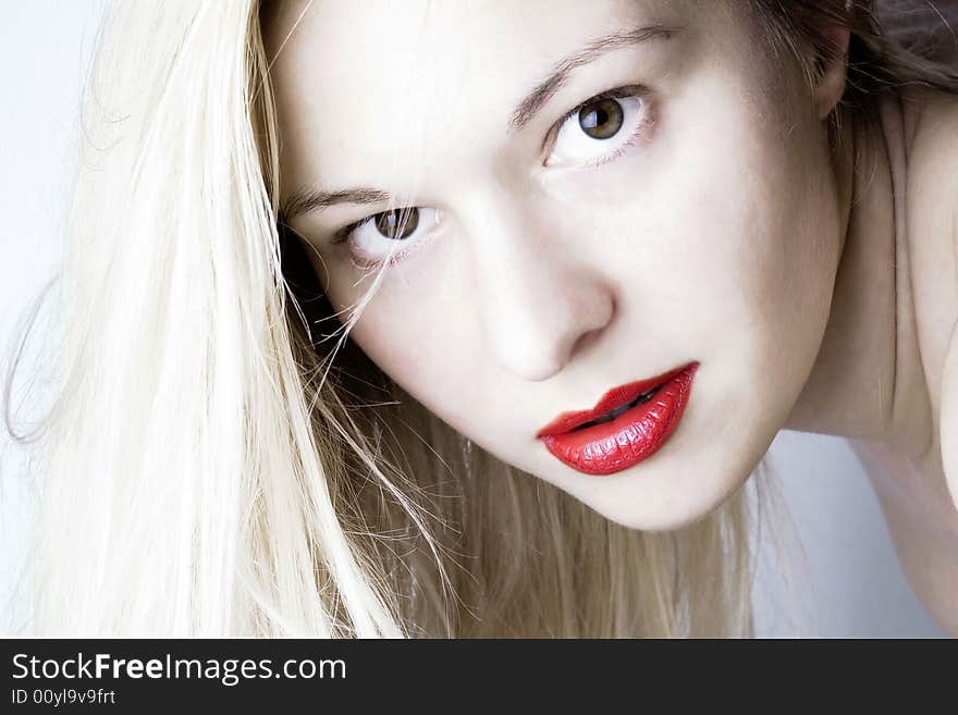 Sensual woman with red lips and blond long hair