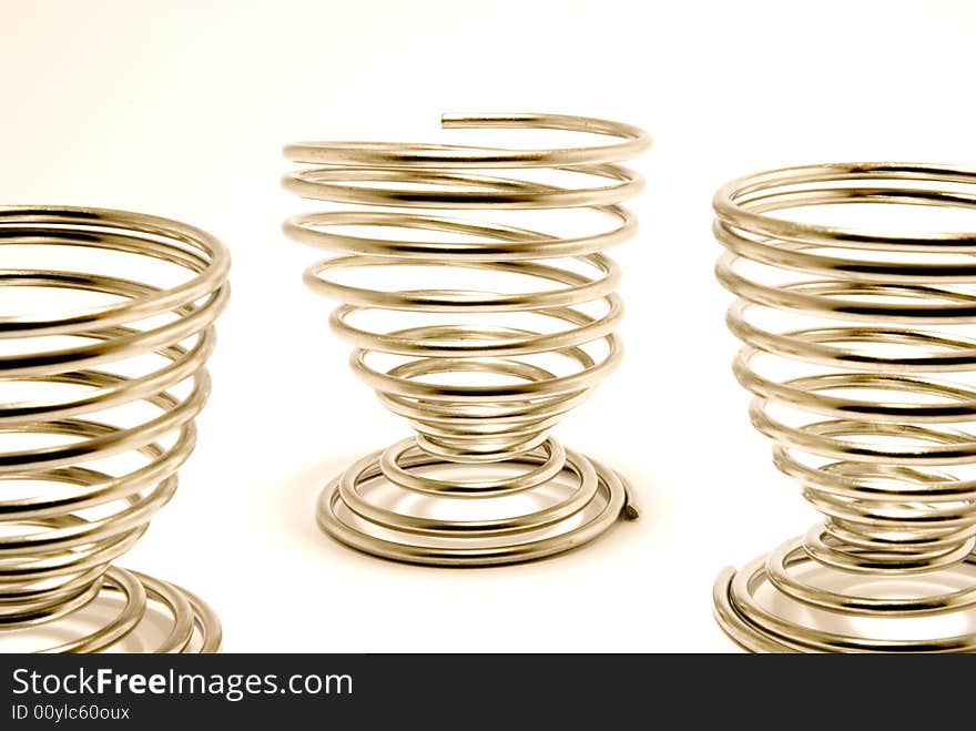 THree egg cups, placed over white background. THree egg cups, placed over white background