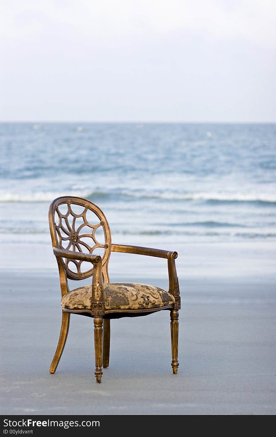 Ornate french chair on ocean beach. Ornate french chair on ocean beach