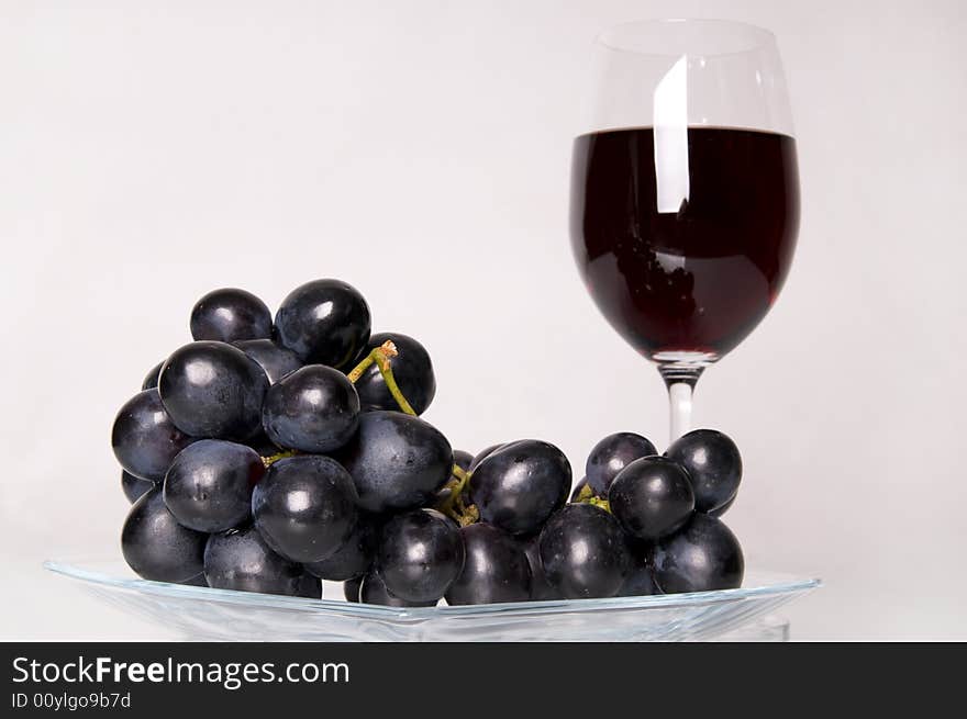 Glass of red wine and grapes. Glass of red wine and grapes.