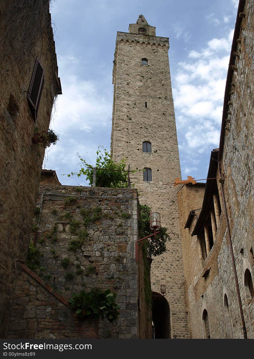 An original shot of the majestic bell's tower of the Cathedral in San Gimignano - Siena