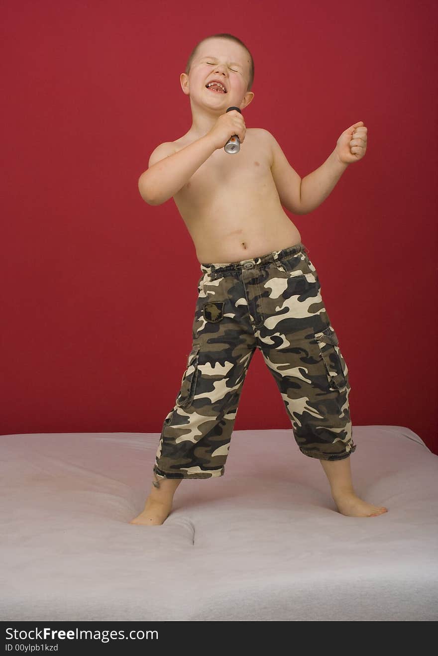 Boy sings, boy in military trousers, party