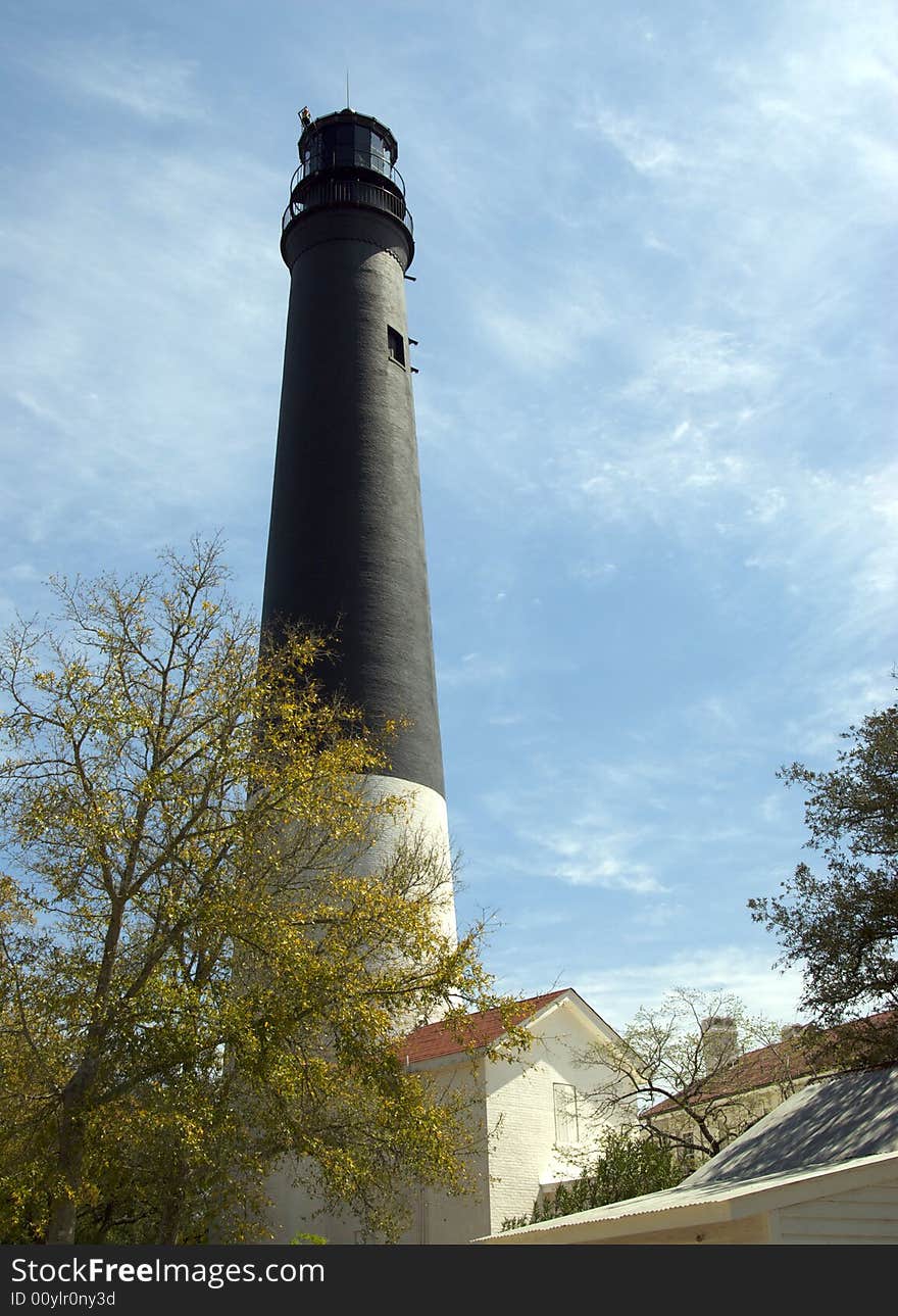 A Classic lighthouse stands guard along the coastline. A Classic lighthouse stands guard along the coastline