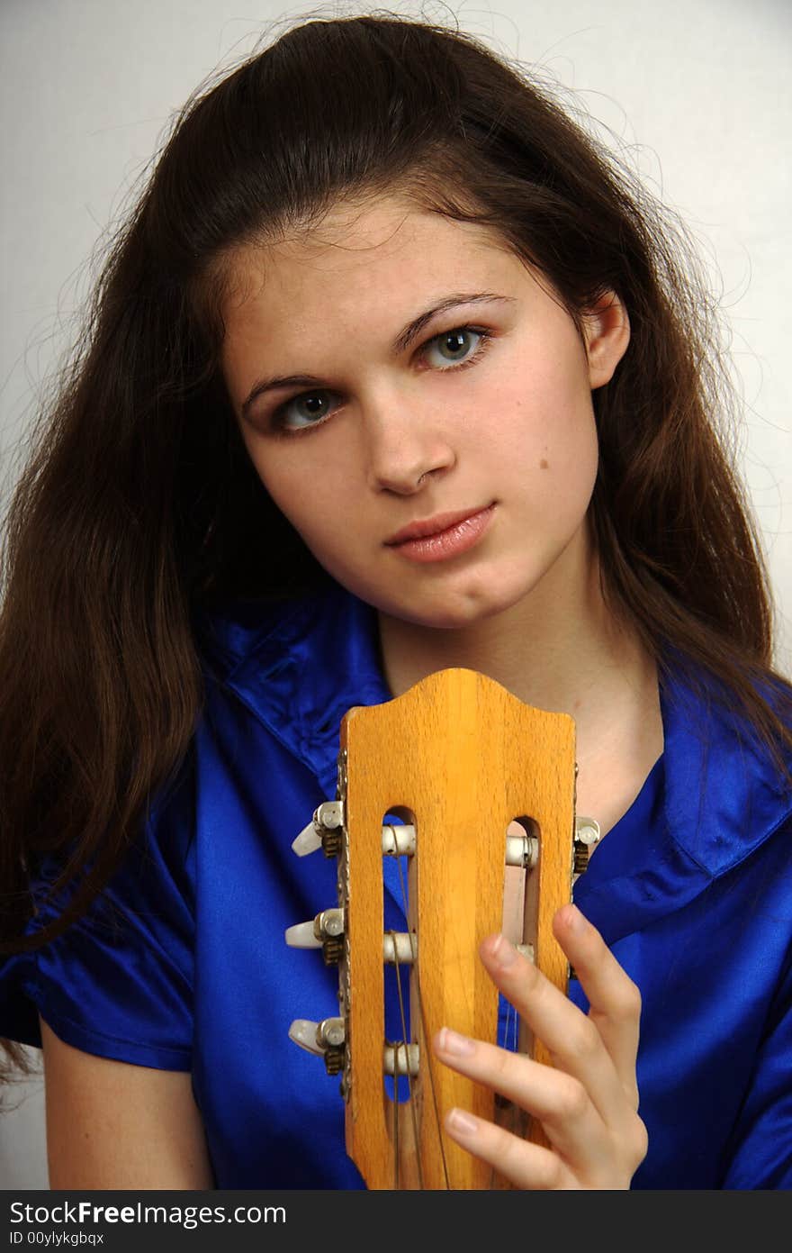 Girl with guitar looking in camera