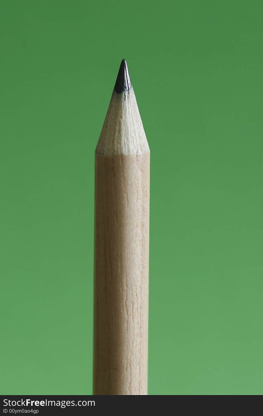 A pencil  with a simple green color background. A pencil  with a simple green color background