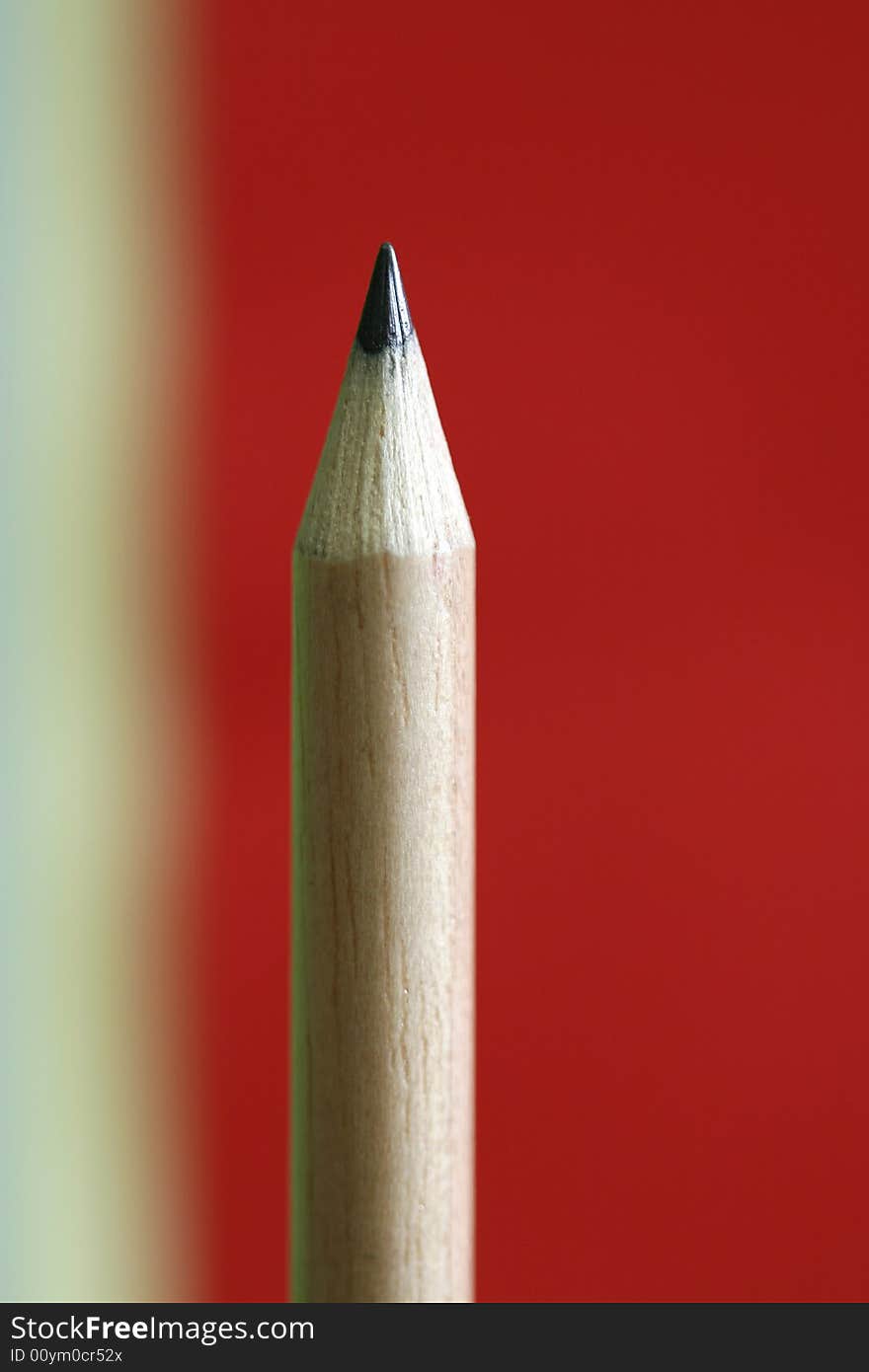 A pencil  with a simple yellow red color background. A pencil  with a simple yellow red color background