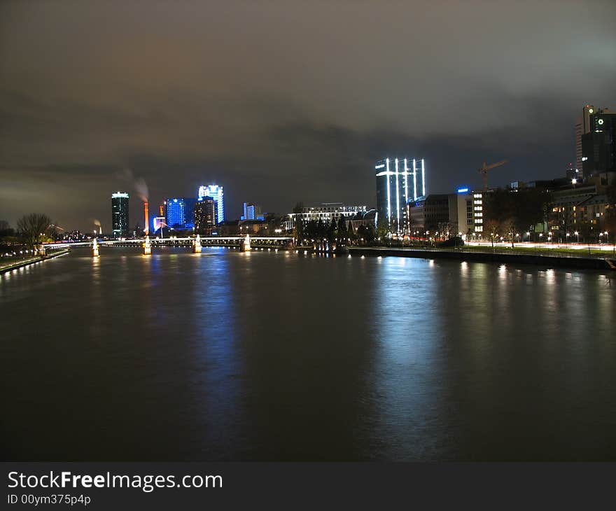 Night shot of lit buildings reflecting in a river. Night shot of lit buildings reflecting in a river