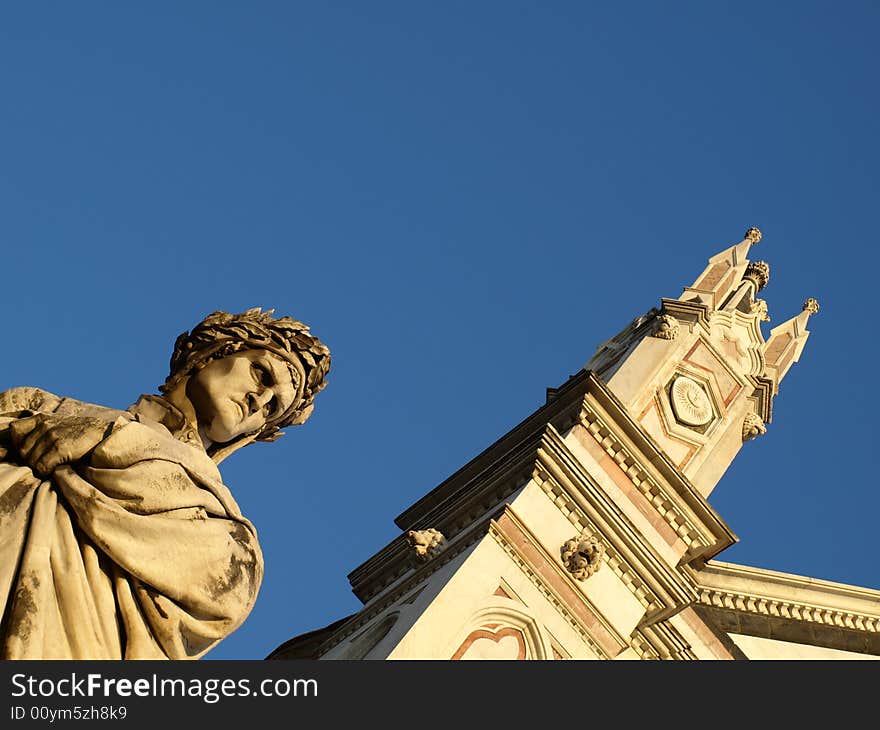 A wonderfull shot of the statue of Dante Alighieri and a glimpse of Santa Croce church in Florence - Italy. A wonderfull shot of the statue of Dante Alighieri and a glimpse of Santa Croce church in Florence - Italy