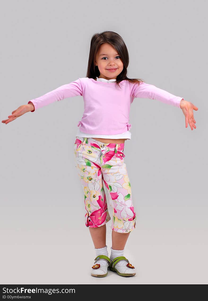 Cute smiling baby girl posing in brightly colored clothes. Cute smiling baby girl posing in brightly colored clothes