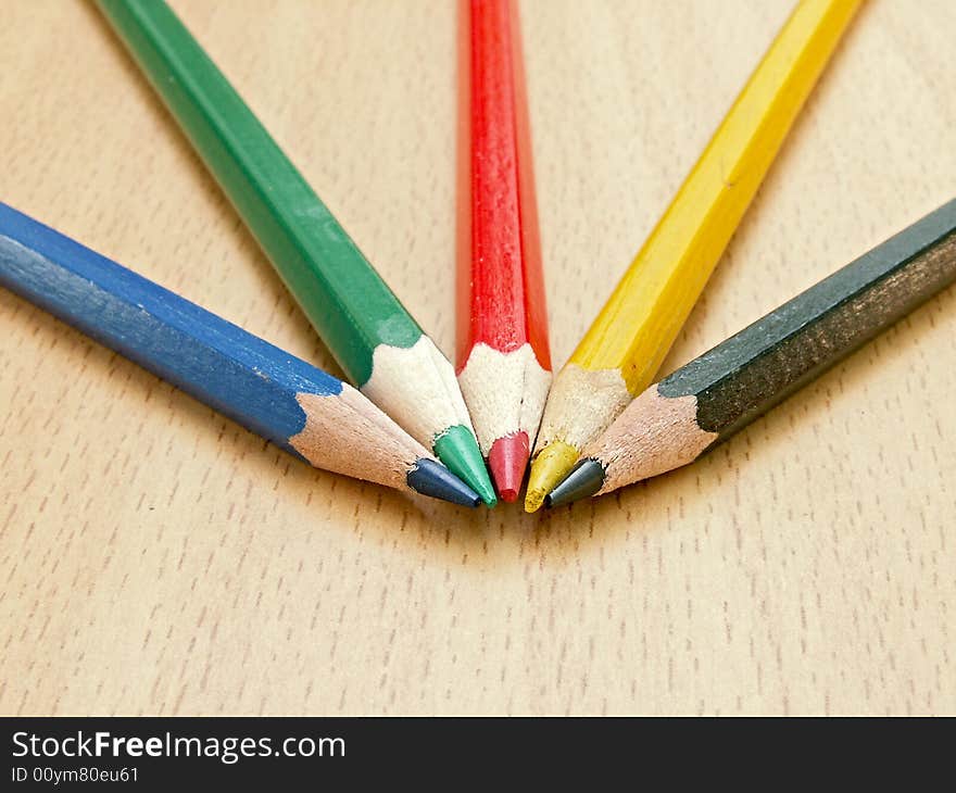 Color pencils lay on a table. The photo is made with small depth of sharpness, camera Konica Minolta Dimage Z5.