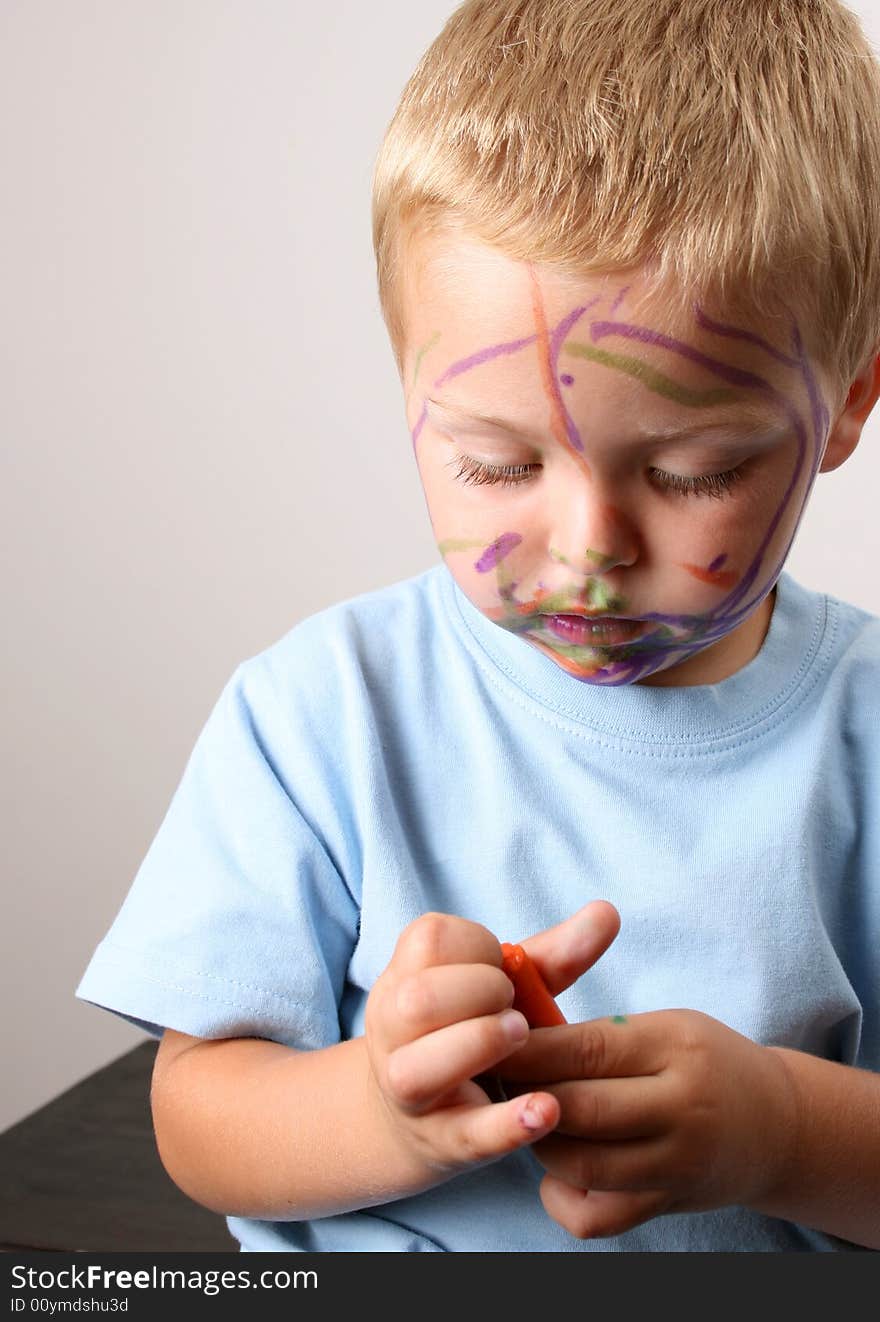 Laughing Toddler playing with colored pens making a mess. Laughing Toddler playing with colored pens making a mess