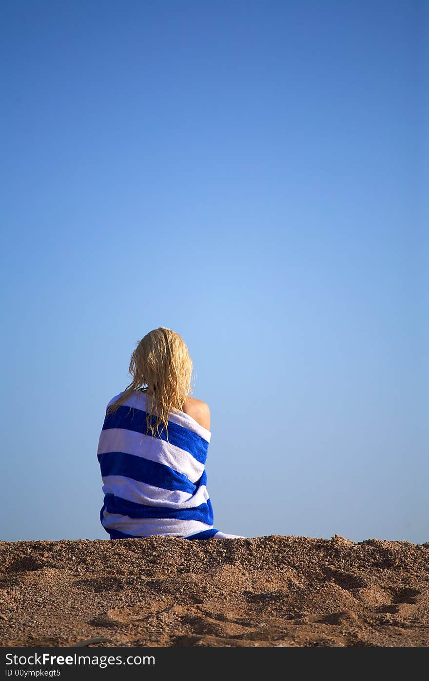 Young woman sits on a sand and meditate. Young woman sits on a sand and meditate.