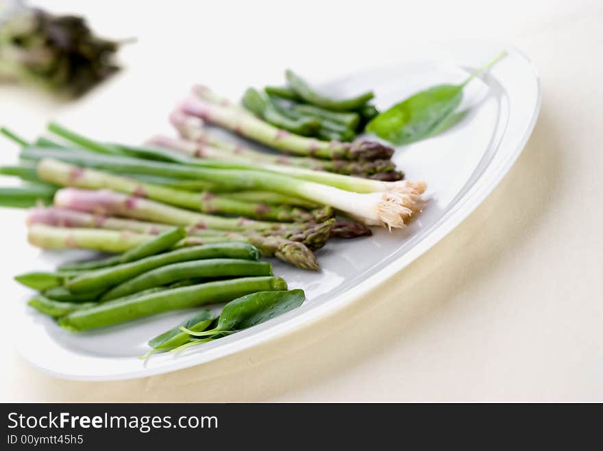 High key image of vegetables on a plate with shallow focus. High key image of vegetables on a plate with shallow focus