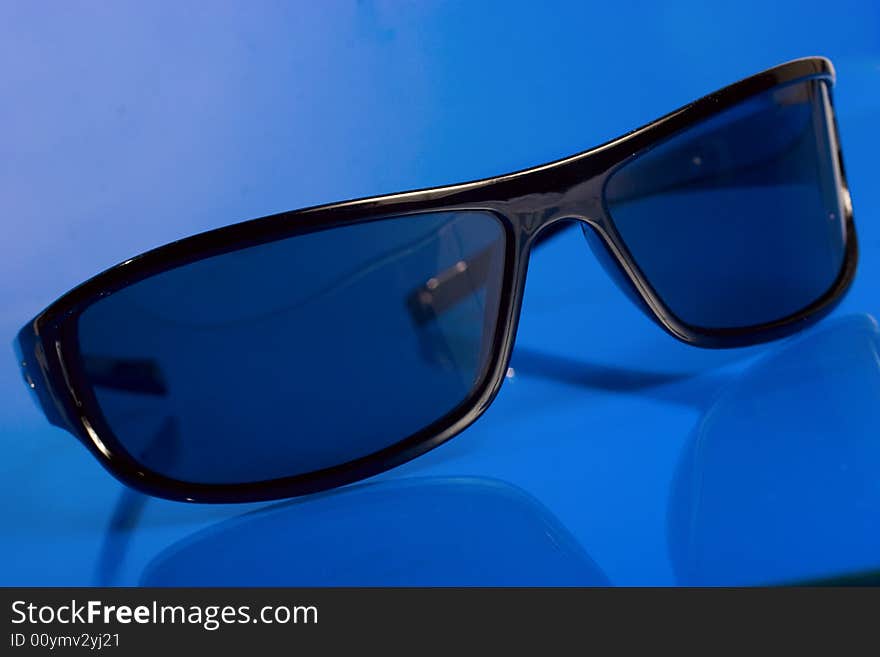 Sunglasses over blue background