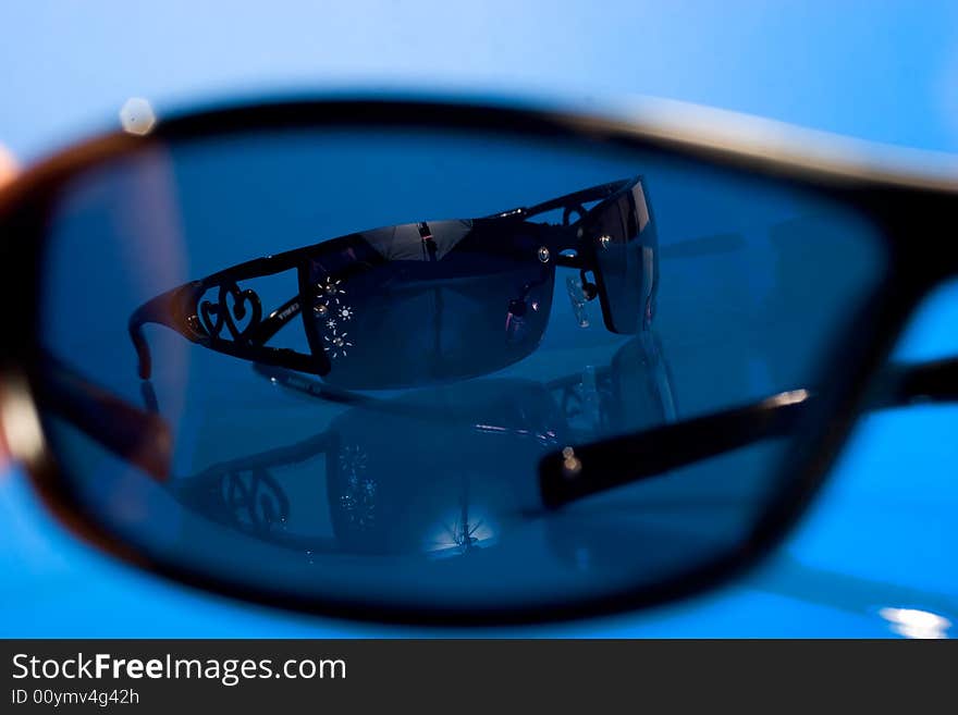 Sunglasses Over Blue Background