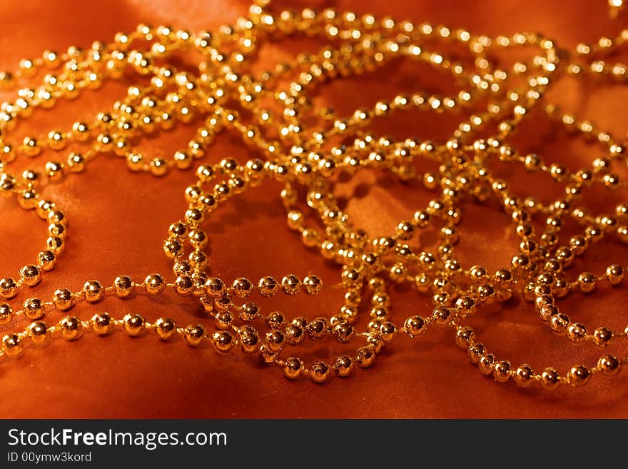 golden beads on silk background. golden beads on silk background