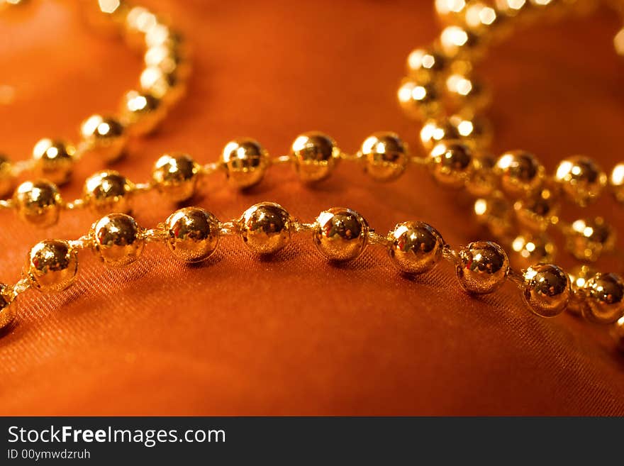 golden beads on silk background. golden beads on silk background