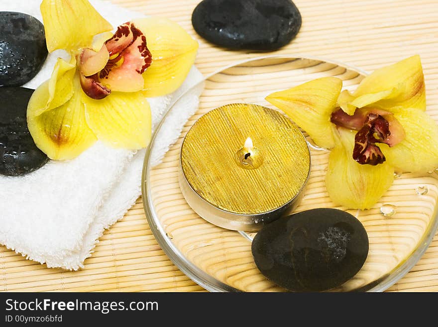 Yellow orchids and towel