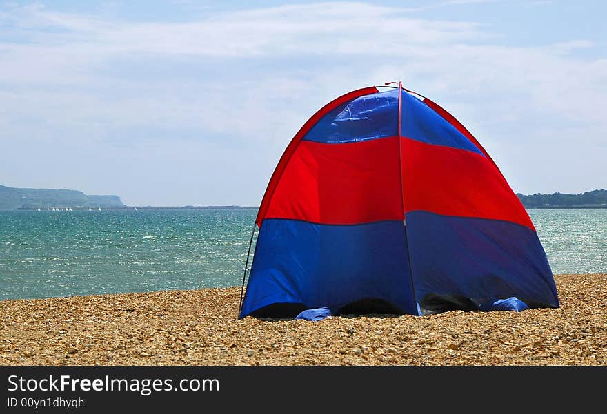 Tent pitched on a stoney beach. Tent pitched on a stoney beach