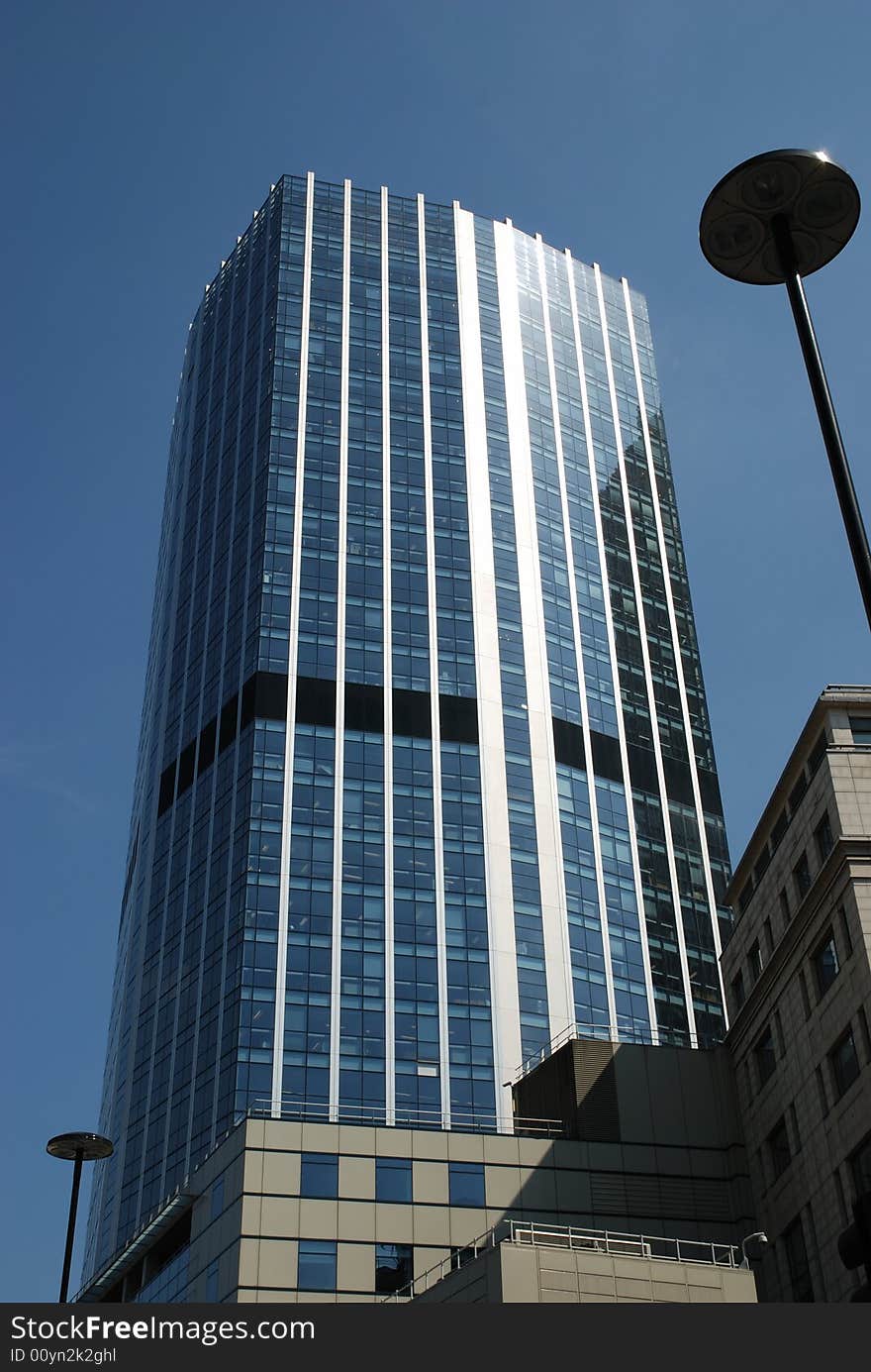 Canary Wharf office block skyscraper against a strong blue sky. Canary Wharf office block skyscraper against a strong blue sky.