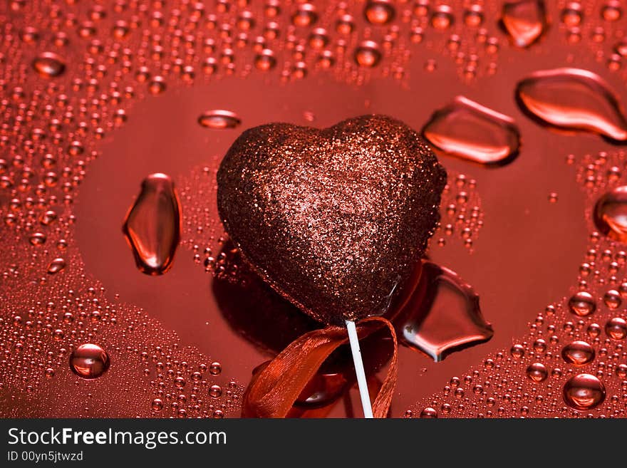 Holidays card, heart on background with water droplets