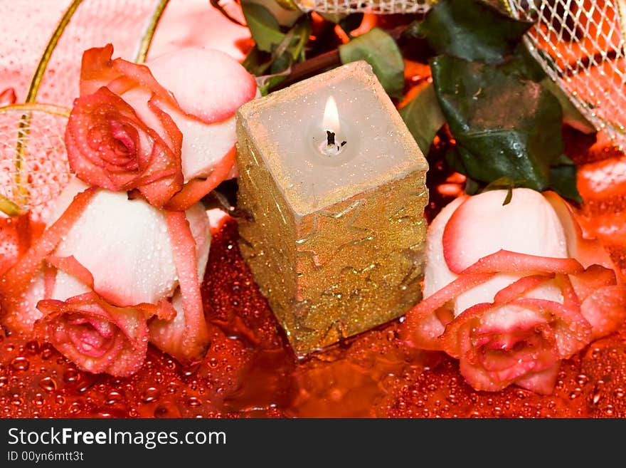 Golden candle with red roses