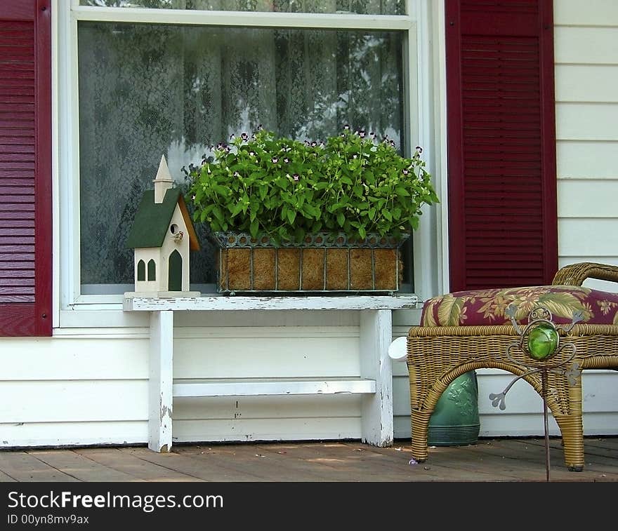 A front porch of a house in a small village. A front porch of a house in a small village.