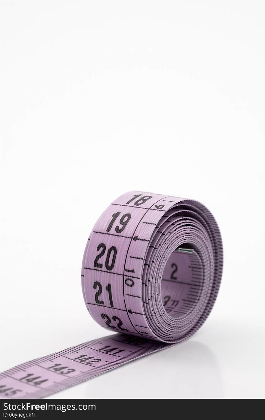 Measuring tape, white background, close up shot. Measuring tape, white background, close up shot.