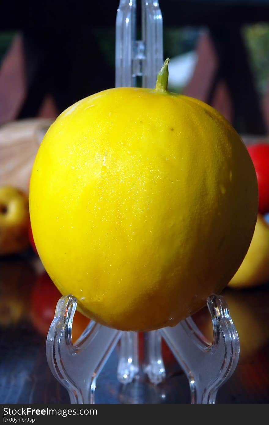 This is the closed-up picture of fresh colorful, energy and  vitamins full melon with the water drops close-up . The watermelon  is on the desk against fruits , wooded garden wall . This is the closed-up picture of fresh colorful, energy and  vitamins full melon with the water drops close-up . The watermelon  is on the desk against fruits , wooded garden wall .