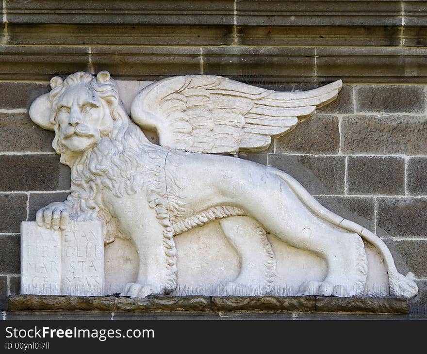 Venetian lion with human face on city gate in Padua, Italy