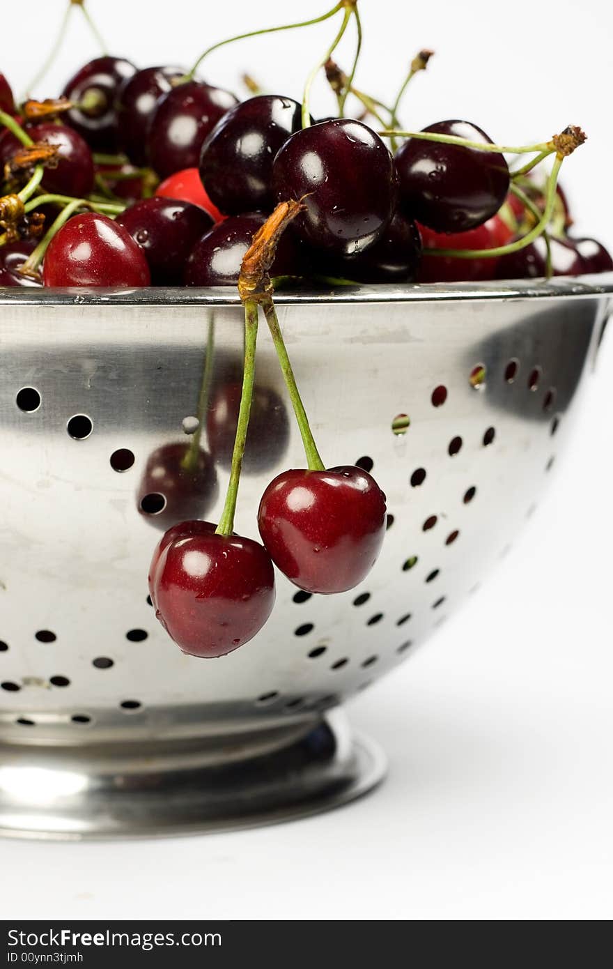 Fresh cherry in Colander on white background. Fresh cherry in Colander on white background