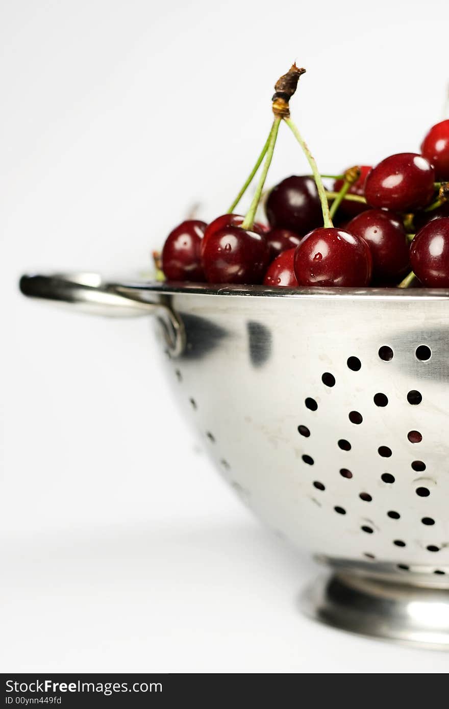 Fresh cherry in Colander on white background. Fresh cherry in Colander on white background