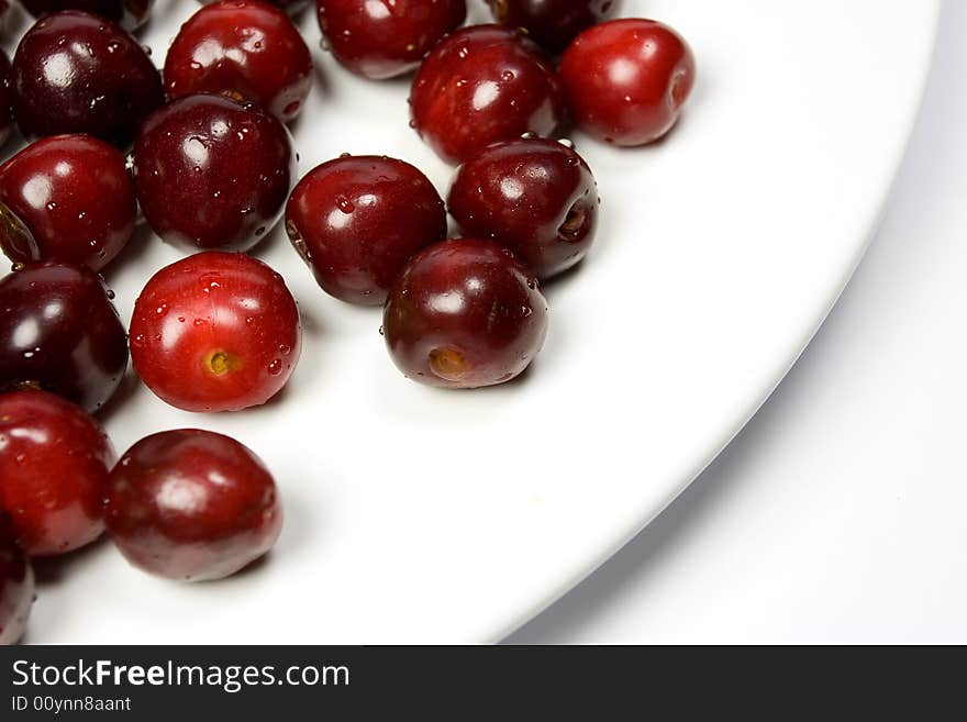 Close-up of fresh cherry on white plate