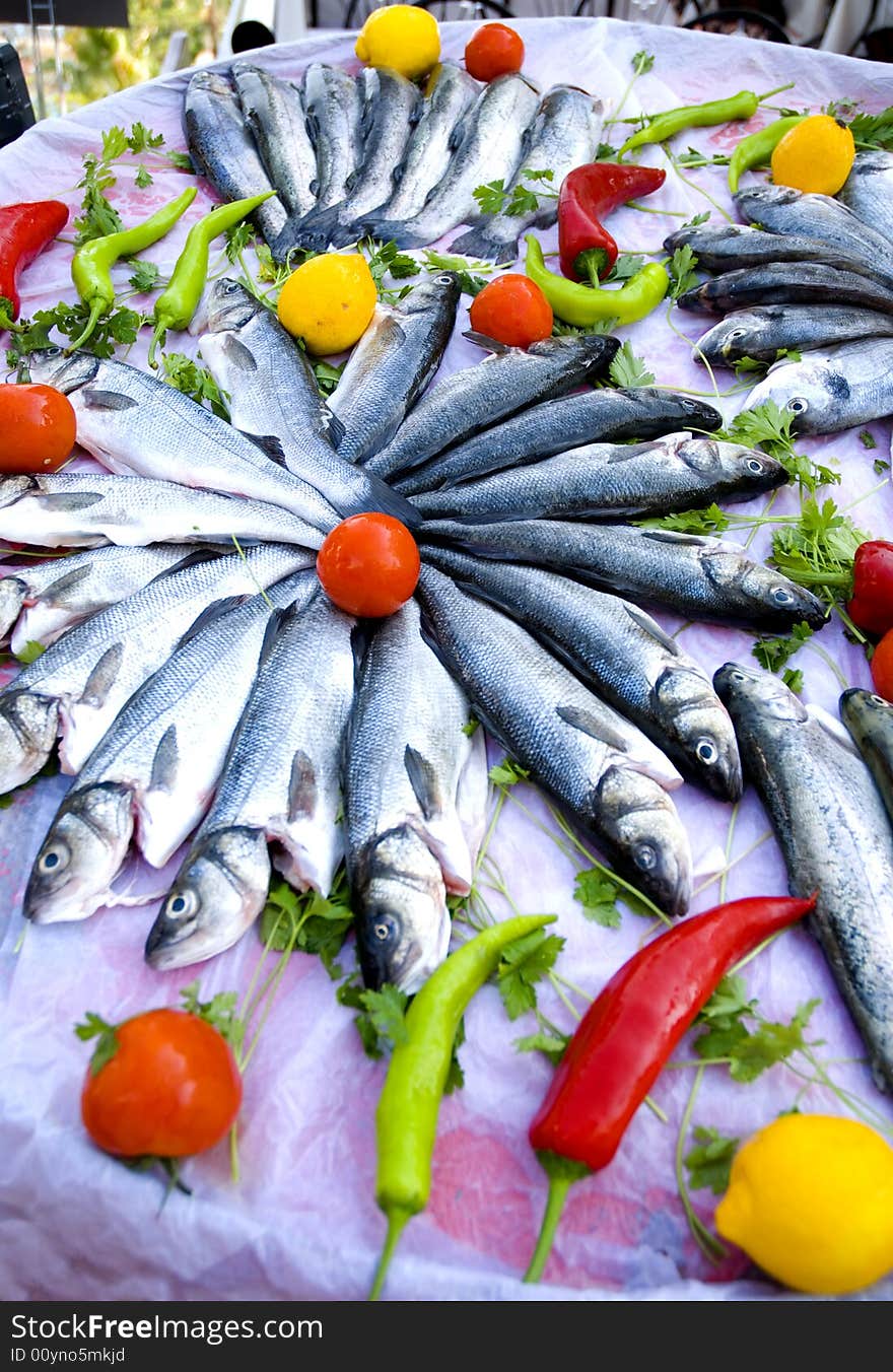 fresh sea bass fish with tomatos close up. fresh sea bass fish with tomatos close up