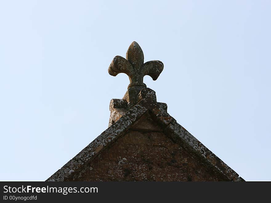 A Stone Plume sits o nthe gable of a chrch roof in Somerset. A Stone Plume sits o nthe gable of a chrch roof in Somerset