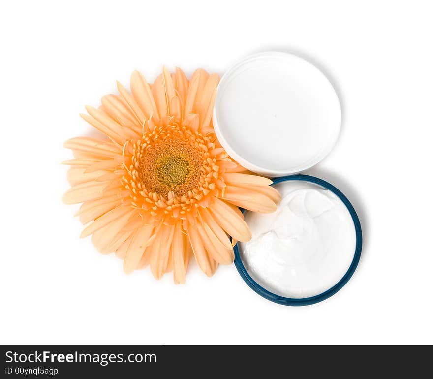 Moisturizing cream with orange gerbera close up