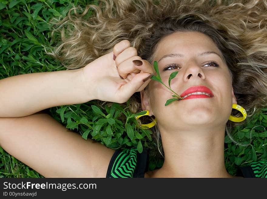 Beautiful girl lying down of grass