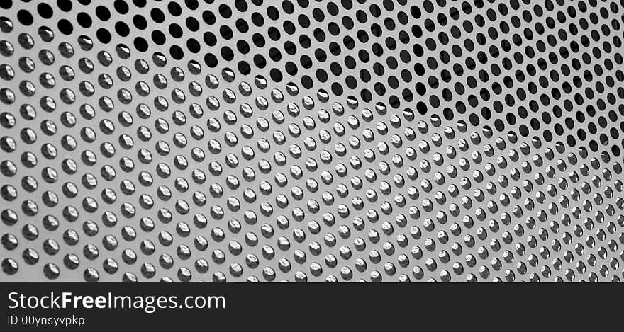 Graphic design detail of a grid in aluminum on a building surface