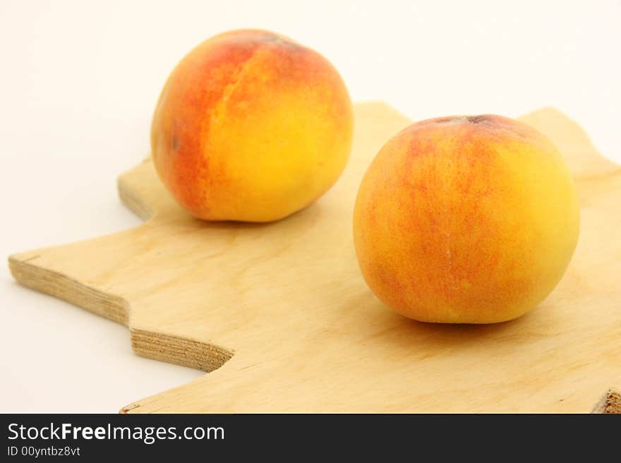 Peaches on woody kitchen board