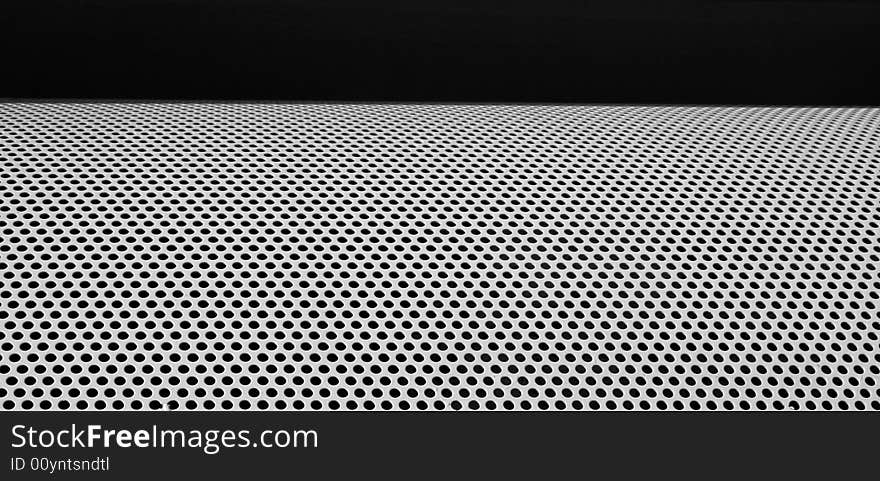 Graphic design detail of a grid in aluminum on a building surface