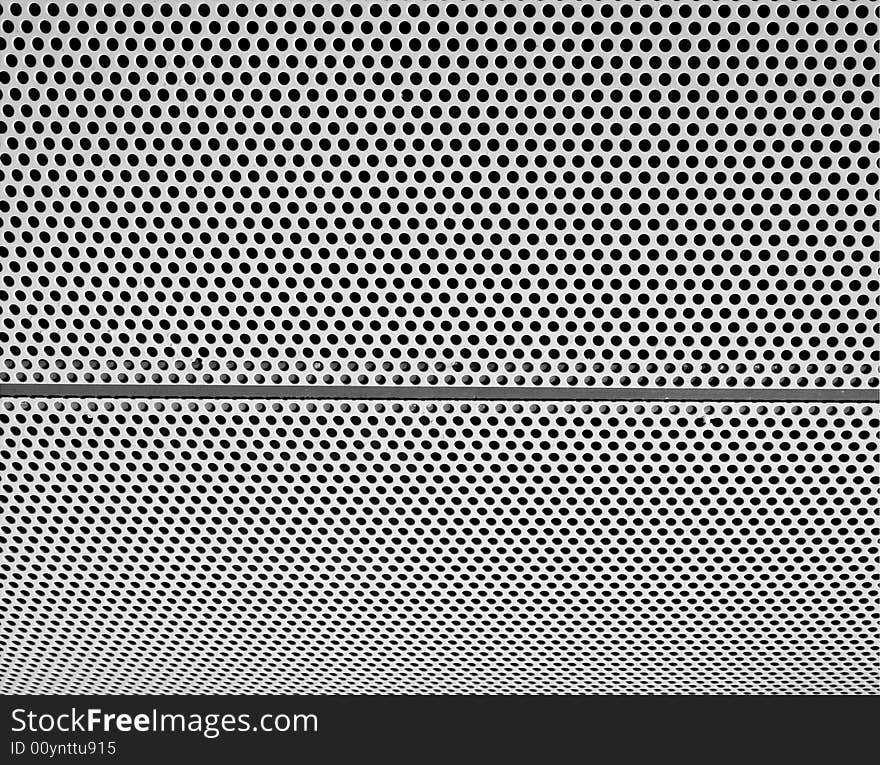 Graphic design detail of a grid in aluminum on a building surface