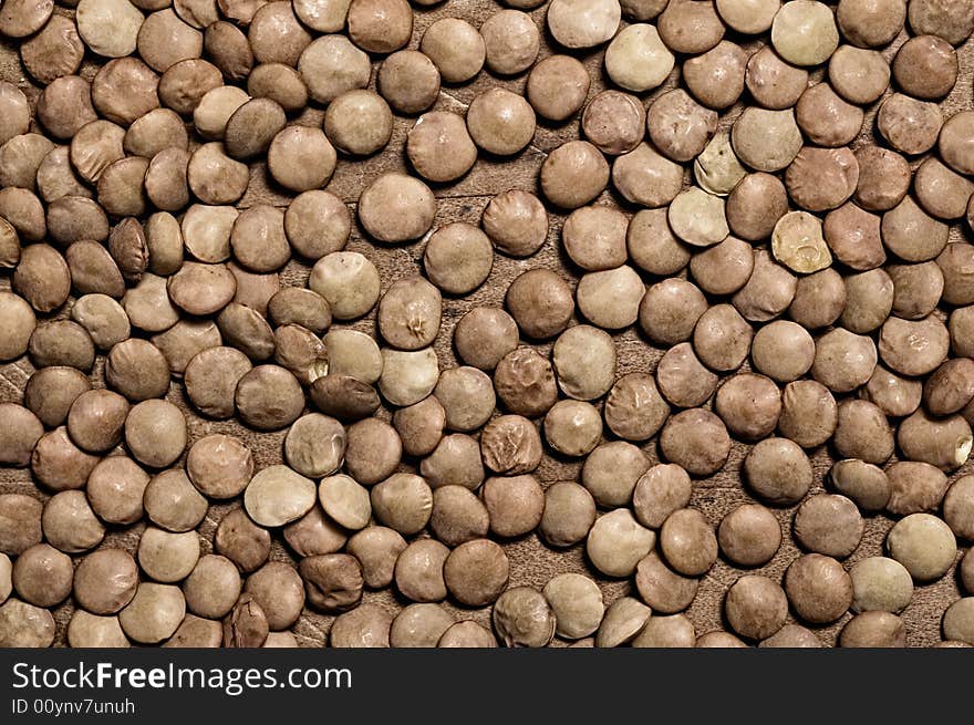 Lentils on wooden table.