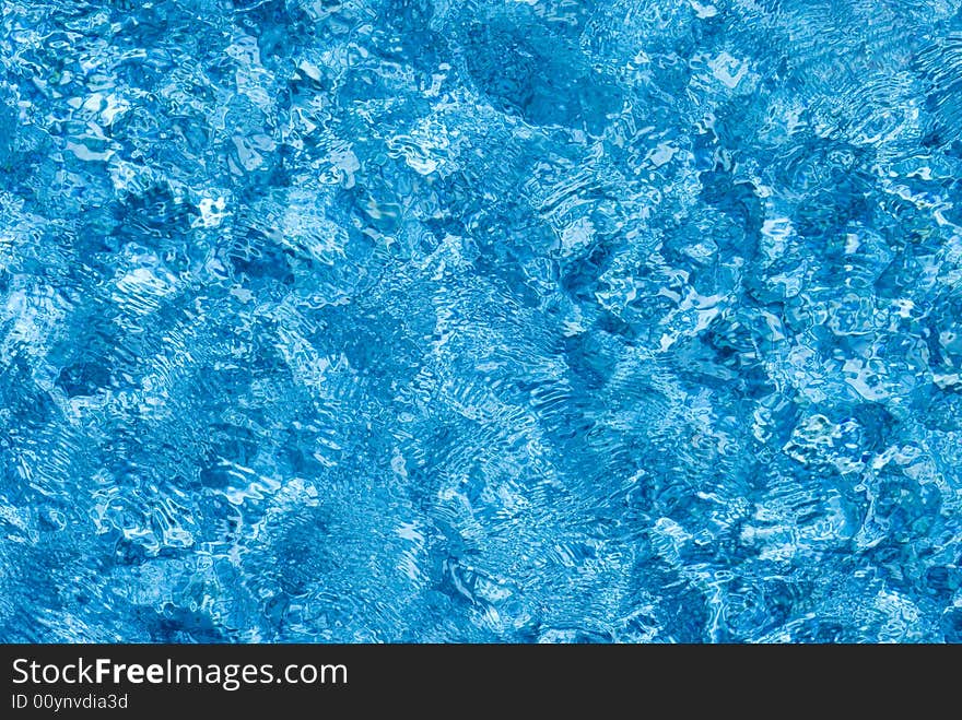 The surface of blue water as it is being blown by the wind. The surface of blue water as it is being blown by the wind.