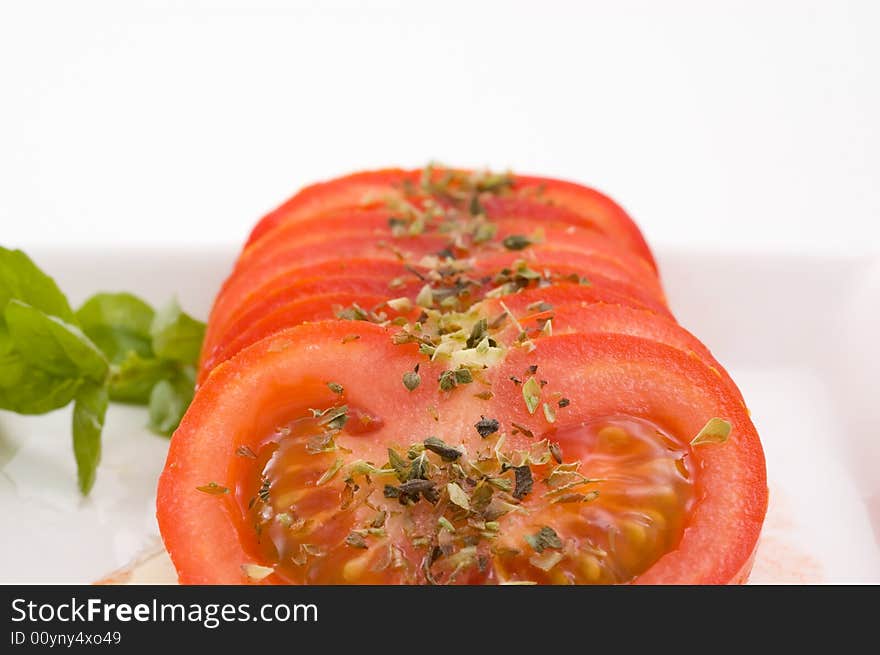 Tomato slices with basil and oregano