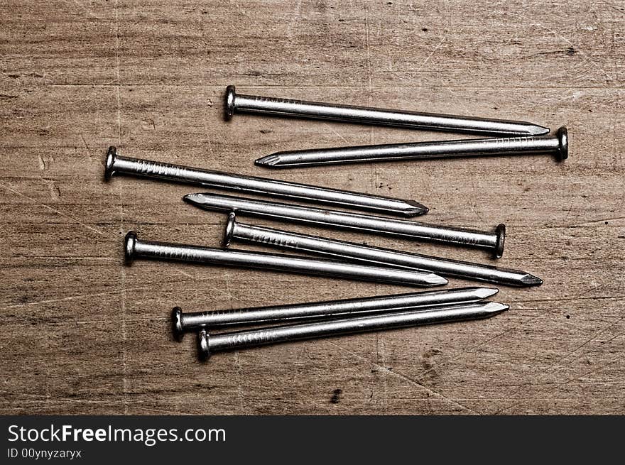 Nails on wooden table.