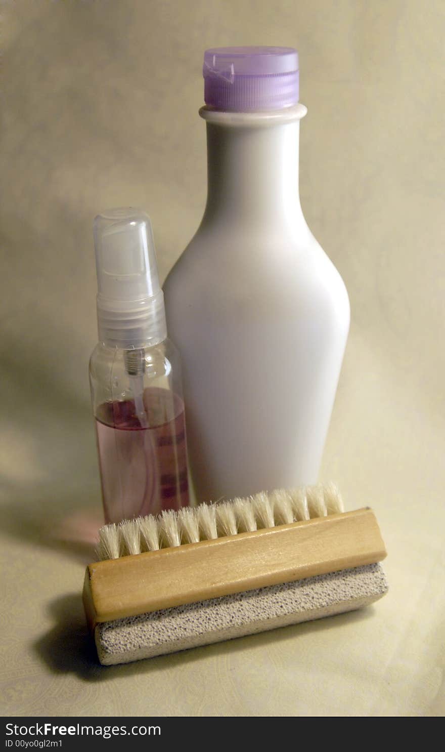 A still life of lotion, body spray, and a body loofah and brush. A still life of lotion, body spray, and a body loofah and brush.